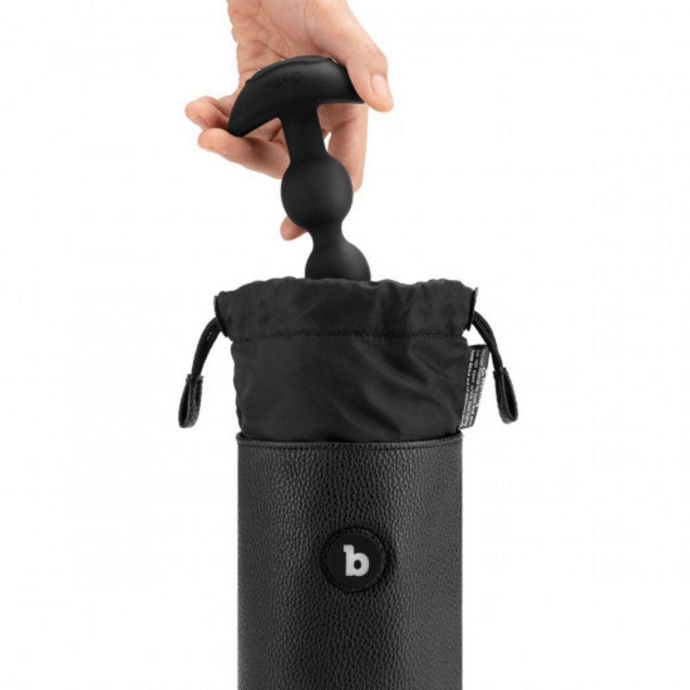 A toy being put into the B-Vibe UV Sterilizer Pouch