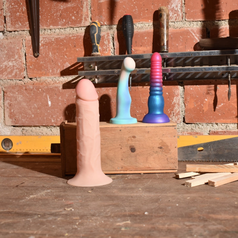 EssentialDrillBitsbundlephotowith3dildosinaworkshopsetting